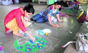 Participants prepare rangolis in a competition held at the Jammu University on Tuesday.