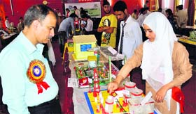 A student displays a modal to the chief guest GA Quershi, director of the school education, at the science exhibition held at the Government Girls High Secondary School.