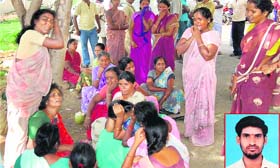 Relatives of Vijayaraj (inset), who immolated himself, mourn outside a government hospital in Salem on Tuesday.