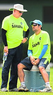 Coach Duncan Fletcher (L) speaks with captain MS Dhoni at a training session at Nondescripts Cricket Club in Colombo ahead of Group A match against Afghanistan on Wednesday.