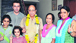 Newly elected Mayor Bakshi Ram Arora stands with family members at his residence in Amritsar on Wednesday