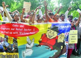 Street vendors shout anti-UPA government slogans during a protest against the decision to allow the FDI in retail sector at Jantar Mantar in New Delhi on Wednesday