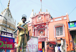 A CRPF man stands guard outside the Raghunath Temple in Jammu. A Tribune file photo