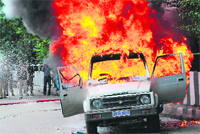 A vehicle set ablaze by protesters on Tuesday. 