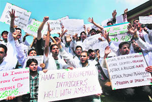 Medical students hold placards during a protest march against America and Israel for the anti-Islam film in Srinagar on Wednesday.