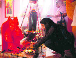 A woman devotee performs pooja inside the Ganpatyar Temple on the occasion of Ganesh Chaturthi in Srinagar on Wednesday.