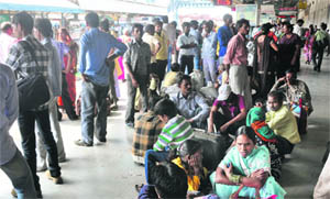 Due to inadequate seating arrangement, passengers forced to sit on a platform