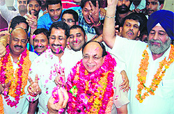 ewly elected BJP Mayor Bakshi Ram Arora flanked by SAD Senior Deputy Mayor Avtar Singh Truckanwala (right) and Deputy Mayor Avinash Jolly in Amritsar on Thursday
