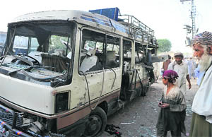 The wreckage of the Pakistan Air Force bus that was blown up in Peshawar on Wednesday. The police said over 100kg explosives were used in the attack.