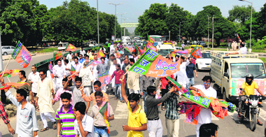 BJP workers hold a protest march on the Madhya Marg, Sector 26, in Chandigarh. 