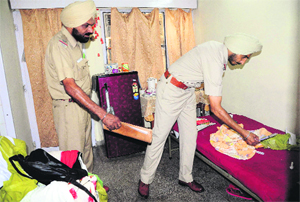 Police officials inspect the room where Rajbir Kaur allegedly committed suicide at the Nurses Hostel, Sector 32, in Chandigarh