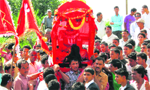 Devotees carry a palanquin of deity Mostamanu in Pithoragarh on Thursday. 