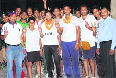 Enthused over their selection in the Indian squad, Raj Kumar Hooda and Sumit Kumar along with their coach, Joginder Arya (extreme left), make the victory sign. 