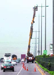 An electrician at work on the Delhi-Jaipur National Highway, near Gurgaon.