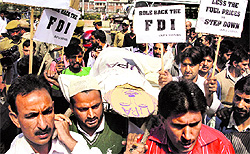 BJP workers carry a coffin of the UPA government during a protest against FDI in retail and diesel price hike in Srinagar on Thursday