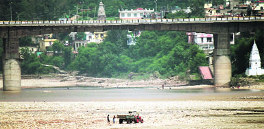 A tractor trolley collects gravel from the Tawi riverbed in Jammu despite district administrations prohibitory orders on mining activities. A Tribune photograph