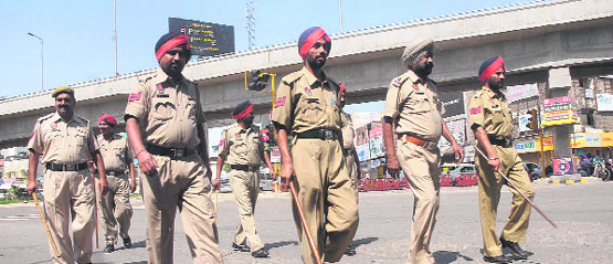 Punjab Police personnel patrol the road at BMC Chowk during Bharat Bandh in Jalandhar or Thursday. Tribune photo: Malkiat Singh