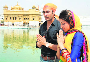 Actors of Punjabi film Aish Karla, Aman Badwal (right) and Aman Randhawa, pay obeisance at the Golden Temple in Amritsar on Friday.