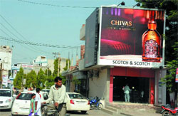 A hoarding installed at a liquor vend on the Bathinda-Goniana road. Tribune photo: Pawan Sharma