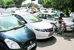 Vehicles parked haphazardly outside the PAU that led to traffic snarls in Ludhiana on Friday