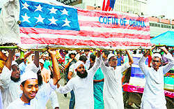 Protesters march with a mock coffin of US President Barack Obama during a protest against satirical cartoons and a film mocking Islam in Dhaka on Friday