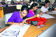 Students participate in cartooning and sketching contest in Jammu on Saturday