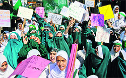 Students raise anti-US slogans during a protest against the anti-Islam film