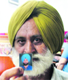 Jarnail Singh shows the picture of his son in Ludhiana on Saturday.
