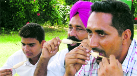 Farmers relish ice-cream during the Kisan Mela at Punjab Agricultural University in Ludhiana.