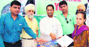Technical Education and Industrial Training Minister Anil Joshi (third from left) gives away a sewing machine to a girl in Amritsar on Sunday. 