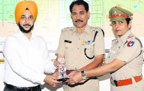 Cyber trainer Manpreet Singh (extreme left) being awarded by the police.