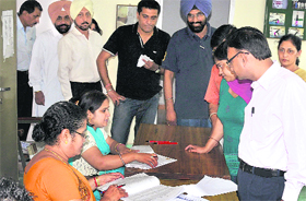 People wait in a queue to cast their votes for the Panjab University Senate at Government Model Senior Secondary School in Sector 37, Chandigarh, on Sunday.