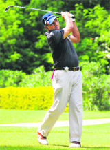 A golfer plays a shot during a tournament in Chandigarh on Sunday.
