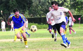 Players in action during the Dehradun District Football League in Dehradun on Sunday. 