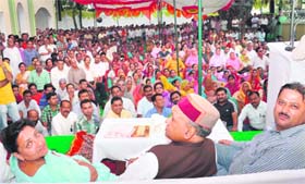 Social Justice and Environment Minister Sarveen Chaudhary, Chief Minister PK Dhumal and MLA Sanjay Kumar at a public meeting in Kangra on Sunday