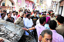 Police personnel and area residents at the site of the explosion in Jammu on Sunday