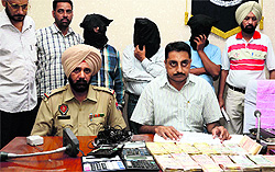 Police officials with three bookies at a press conference in Ludhiana on Sunday