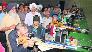 Governor Shivraj Patil tries his hand at a rifle. 