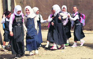 Iraqi children walk to school on Sunday morning after three months of summer vacation in Baghdad