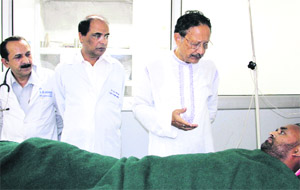 Former state Chief Minister and BJP leader BC Khanduri inquires about the health of a patient in Dehradun on Monday. 