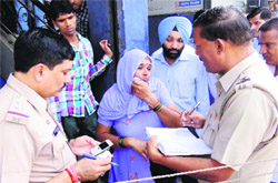 Suman cries after being looted in Karnal on Monday. 