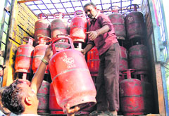 A consumer takes delivery of an LPG cylinder directly from the supply vehicle in Jammu on Monday. Tribune photo: Inderjeet Singh
