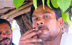A labourer smokes at a public place in Jalandhar.