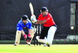 A batsman plays a shot during the final match of the JP Atray cricket tournament at the PCA Stadium in Mohali on Tuesday.