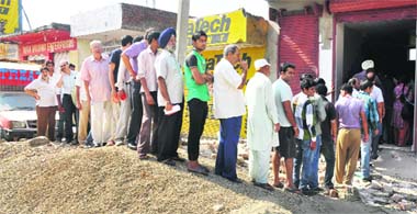 Consumers make a beeline outside the LPG counter in Channi Himmat area of Jammu on Tuesday. 