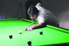 A cueist in action during the ongoing Jammu District Open Junior and Senior Billiards and Snooker Championship at MA Stadium in Jammu on Tuesday.