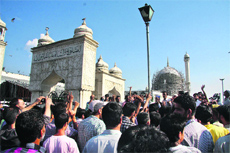 People raise slogans against the Waqf Board after the damage to the dome of the Hazratbal shrine on the outskirts of Srinagar. Some marble tiles came off during the renovation work. 