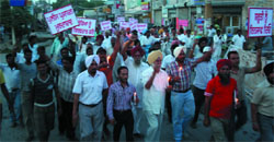 Residents carry out a candle-light procession in protest against failure of the police to recover a minor girl who was kidnapped from Faridkot town, on Wednesday. A Tribune photograph