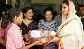 MP Harsimrat Kaur Badal presents a gift to a student of the Chetak Asha School at Bathinda military station. 