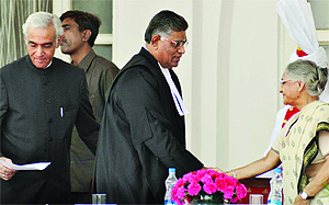 Chief Minister Sheila Dikshit greets Justice D. Murugesan after he took oath as the Chief Justice of the Delhi High Court in New Delhi on Wednesday. Also seen is Lieutenant Governor Tejender Khanna